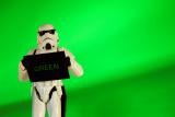 Literal white person holding a black sign with the word 'green' in green letters